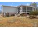 Gray house exterior with screened porch and fire pit at 15918 Big Bear Rd, Albemarle, NC 28001