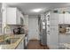 Galley kitchen with granite countertops and white cabinets at 15918 Big Bear Rd, Albemarle, NC 28001