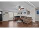 Living room features L-shaped sofa, ceiling fan, and fireplace at 15918 Big Bear Rd, Albemarle, NC 28001