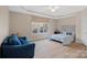 Relaxing bedroom featuring light-filled windows, tray ceilings, and a pleasant, neutral color scheme at 162 Wild Harbor Rd, Mooresville, NC 28117