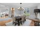 Dining room features wood flooring, a chandelier, and large windows with natural light at 162 Wild Harbor Rd, Mooresville, NC 28117