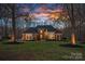 A traditional, brick home is framed by two trees in the front yard with a sunset sky overhead at 162 Wild Harbor Rd, Mooresville, NC 28117