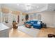 Cozy living room with a plush sofa, hardwood floors, and natural light from the windows at 162 Wild Harbor Rd, Mooresville, NC 28117