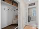 Mudroom with built-in bench, cubbies, and hooks for storage, leading to a laundry room at 162 Wild Harbor Rd, Mooresville, NC 28117