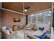 Relaxing sunroom with a hanging daybed, ceiling fan and exposed brick wall at 162 Wild Harbor Rd, Mooresville, NC 28117