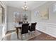 Bright dining room with hardwood floors and wainscoting at 16400 Cozy Cove Rd, Charlotte, NC 28278