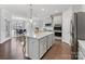 Open kitchen featuring a large island and hardwood floors at 16400 Cozy Cove Rd, Charlotte, NC 28278