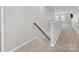 Upstairs hallway with carpeted flooring and staircase at 16400 Cozy Cove Rd, Charlotte, NC 28278