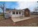 Back patio area with outdoor seating and privacy near a red brick and white vinyl home at 1648 Newton Dr, Statesville, NC 28677