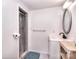 Cozy bathroom featuring a shower with gray tile surround, vanity, and oval mirror at 1648 Newton Dr, Statesville, NC 28677