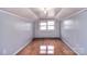 Bedroom with hardwood floors, light gray walls, and a bright window at 1648 Newton Dr, Statesville, NC 28677