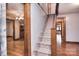 Home entryway with carpeted stairs, wood trim, and views into adjacent living spaces at 1648 Newton Dr, Statesville, NC 28677