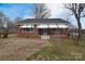 Charming brick home featuring awning-covered windows and a welcoming front porch at 1648 Newton Dr, Statesville, NC 28677