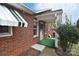 Brick house detail showing a covered entry and green door at 1648 Newton Dr, Statesville, NC 28677