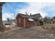 Charming brick home featuring awning-covered windows, a cozy sunroom, and ample parking space at 1648 Newton Dr, Statesville, NC 28677