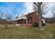 Brick home featuring awning-covered windows and a cozy front porch entrance at 1648 Newton Dr, Statesville, NC 28677