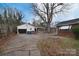 Detached garage with covered parking area and adjacent home with red brick exterior and white trim at 1648 Newton Dr, Statesville, NC 28677