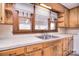 Traditional-style kitchen featuring wood cabinets, a dual basin sink, and natural light from a window at 1648 Newton Dr, Statesville, NC 28677