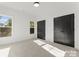 Well-lit bedroom with neutral carpeting and double doors at 2149 Highland St, Charlotte, NC 28208