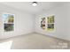 Bright bedroom with neutral carpet and three windows at 2149 Highland St, Charlotte, NC 28208