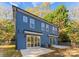 Blue house exterior with sliding glass doors, patio, and fenced backyard at 2149 Highland St, Charlotte, NC 28208