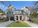 Charming duplex featuring craftsman architecture, symmetrical curb appeal, and attached garages at 2149 Highland St, Charlotte, NC 28208