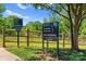 Stewart Creek Greenway entrance featuring signage, landscaping, and walking path for an active outdoor lifestyle at 2149 Highland St, Charlotte, NC 28208