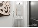 Modern powder room with pedestal sink and black accents at 2149 Highland St, Charlotte, NC 28208