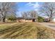 Charming ranch-style home with a covered carport, mature trees, and a well-manicured lawn at 226 Bradley Farm Rd, Statesville, NC 28625