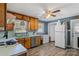 Classic kitchen featuring original wood cabinets and updated stainless steel dishwasher and new flooring at 226 Bradley Farm Rd, Statesville, NC 28625