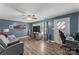 Relaxing living room featuring hardwood floors, a ceiling fan, gaming center and modern entertainment center at 226 Bradley Farm Rd, Statesville, NC 28625