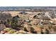 Aerial shot of a rural property showing a home, outbuildings and surrounding landscape at 236 Ervin Rd, Mooresville, NC 28117