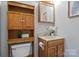 Bathroom featuring wood cabinets, a mirror, and a toilet at 236 Ervin Rd, Mooresville, NC 28117