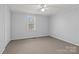 Neutral toned bedroom featuring a ceiling fan, large closet, carpeted floor and window bringing in natural light at 236 Ervin Rd, Mooresville, NC 28117