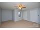 This bedroom has neutral walls, a ceiling fan and two closets and natural light from a window at 236 Ervin Rd, Mooresville, NC 28117