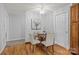 Cozy dining room featuring a glass table, comfortable seating, and hardwood floors at 236 Ervin Rd, Mooresville, NC 28117