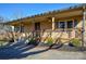 Charming front porch featuring ceiling fans, wood railings and nicely planted landscaping at 236 Ervin Rd, Mooresville, NC 28117