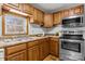 Close up of the kitchen sink with stainless steel appliances, wood cabinets and hardwood floors at 236 Ervin Rd, Mooresville, NC 28117