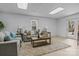 Living room with two couches, a coffee table, two side tables, and natural light from the windows at 236 Ervin Rd, Mooresville, NC 28117