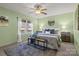 Comfortable main bedroom features a ceiling fan, natural light, and neutral decor at 236 Ervin Rd, Mooresville, NC 28117