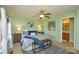 Bright main bedroom features a ceiling fan, bedside lamps, and a decorative bench at 236 Ervin Rd, Mooresville, NC 28117