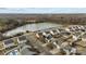 Aerial shot of a neighborhood near a pond surrounded by bare winter trees at 2415 Impatien Dr, Charlotte, NC 28215