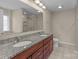 Bathroom boasts double sinks, granite counters, and a tile shower and floor at 2415 Impatien Dr, Charlotte, NC 28215