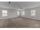 Spacious bedroom featuring neutral walls, carpeted floors and natural light from three windows at 2415 Impatien Dr, Charlotte, NC 28215