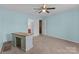 Bedroom featuring light blue walls, neutral carpet, ceiling fan and two closets at 2415 Impatien Dr, Charlotte, NC 28215