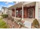 Inviting front porch with brick accents, decorative seating, and charming landscaping at 2415 Impatien Dr, Charlotte, NC 28215