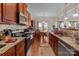 Well-equipped kitchen featuring granite countertops and wooden cabinetry at 2415 Impatien Dr, Charlotte, NC 28215