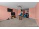 This living room features two TVs, a ceiling fan, and carpeted floors at 2415 Impatien Dr, Charlotte, NC 28215