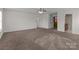 Spacious living room featuring neutral walls, carpeted floors and natural light from windows at 2415 Impatien Dr, Charlotte, NC 28215