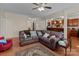 Spacious living room featuring hardwood floors and a comfortable sectional sofa at 2415 Impatien Dr, Charlotte, NC 28215